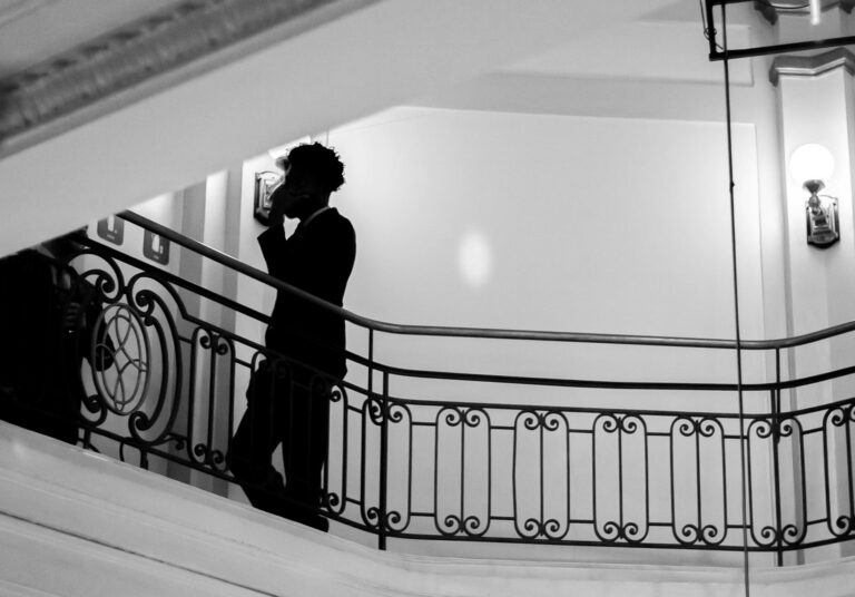 a man is standing on the stairs of a building